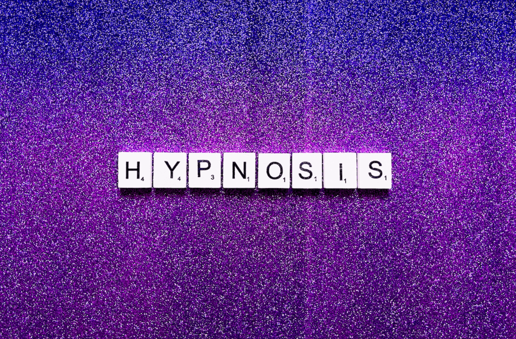 scrabble letters spelling 'hypnosis'