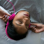 woman-listening-to-music-while-sleeping-on-bed-2022-02-02-03-49-20-utc-1